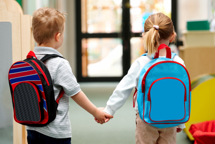 Back to school - Kids with different style back packs holding hands
